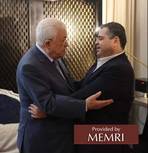 PA President Abbas embraces Abd Al-Salam Haniya during their meeting